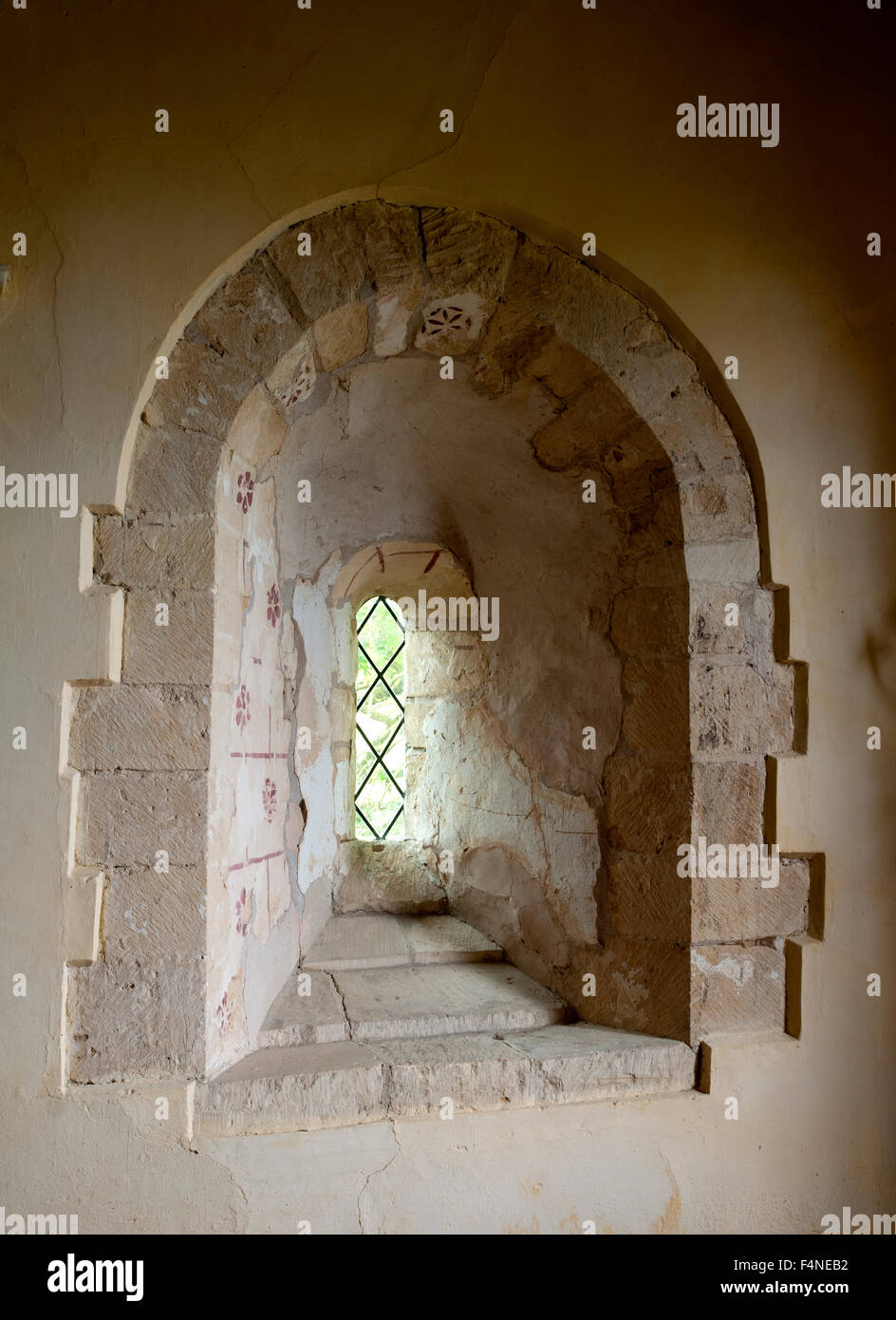 Norman window in St. Mary`s Church, Little Washbourne, Gloucestershire, England, UK Stock Photo